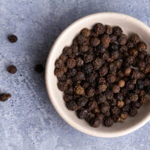 brown coffee beans on white ceramic bowl